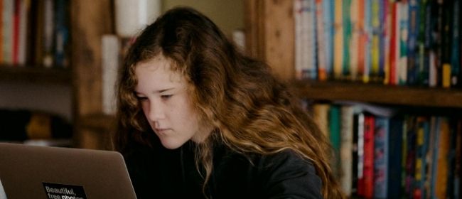 Girl studying on computer.