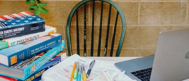 Textbooks and notes on table.