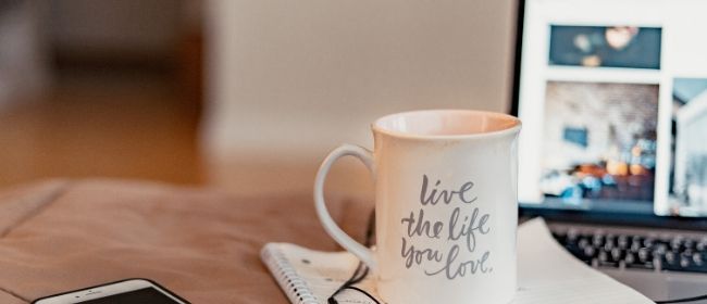 Mug and laptop on table.