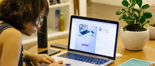 Girl studying on laptop.