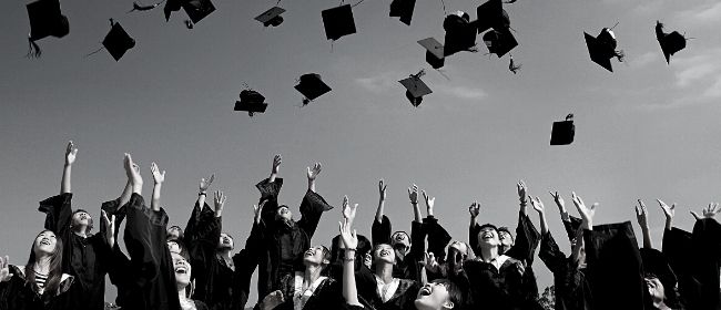 Graduates throwing their caps in the air.